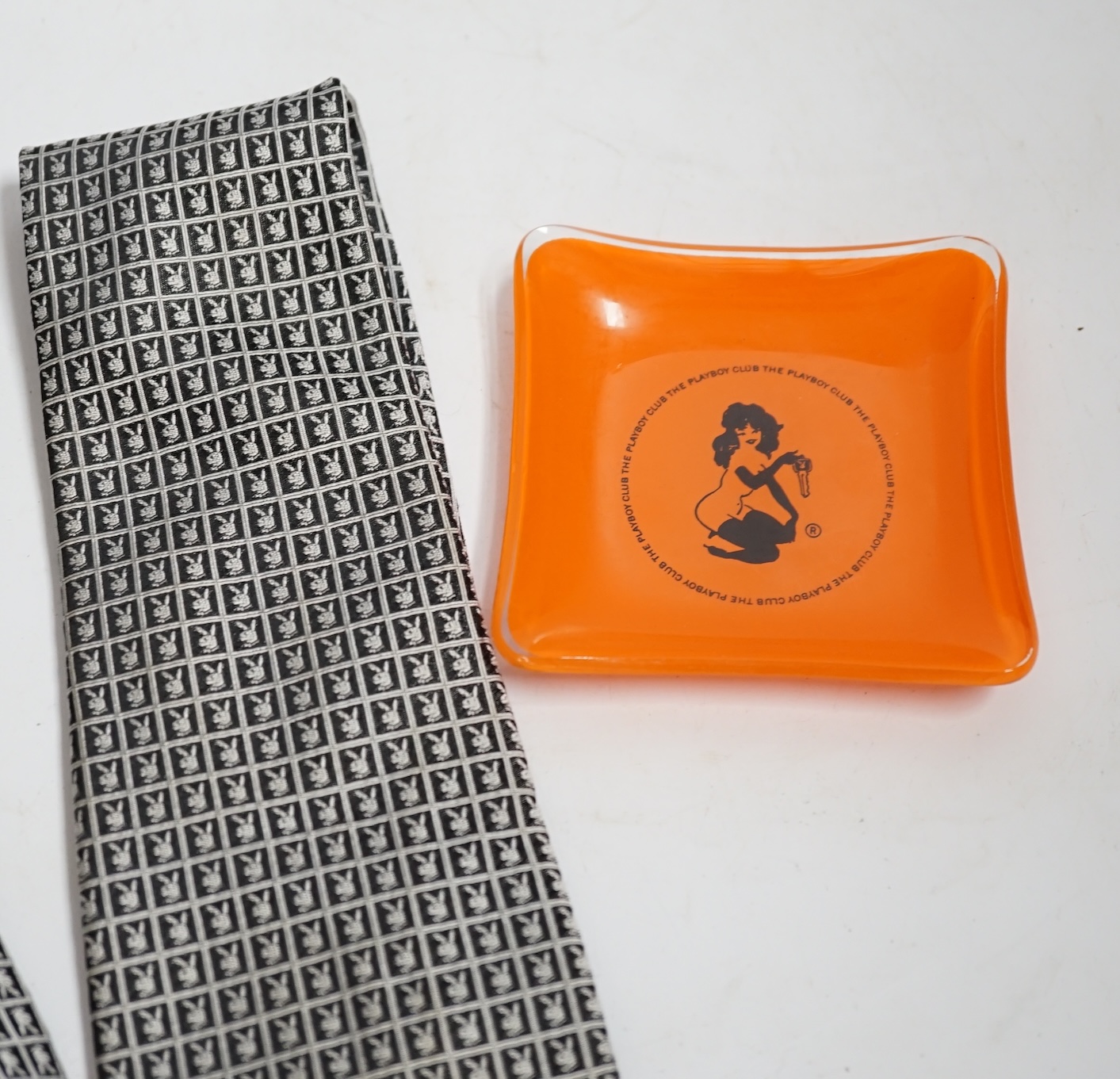 Playboy memorabilia: a tie, an ash tray, two packs of matches, a towel and a pair of cuff links